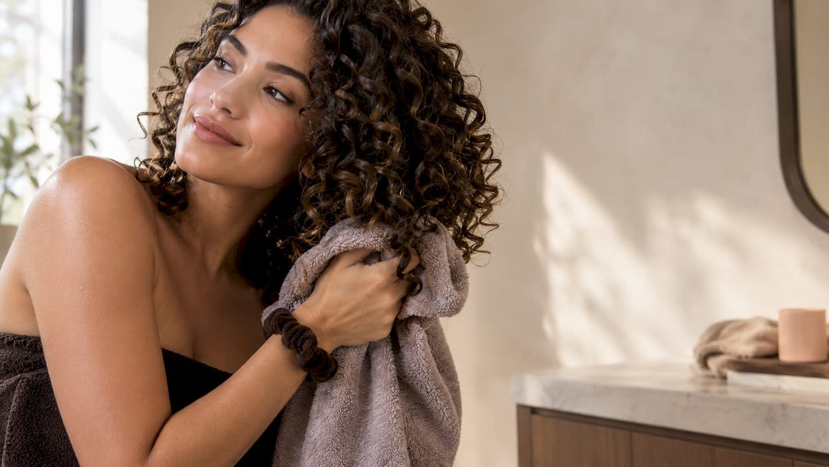 Curly hair being gently dried without frizz