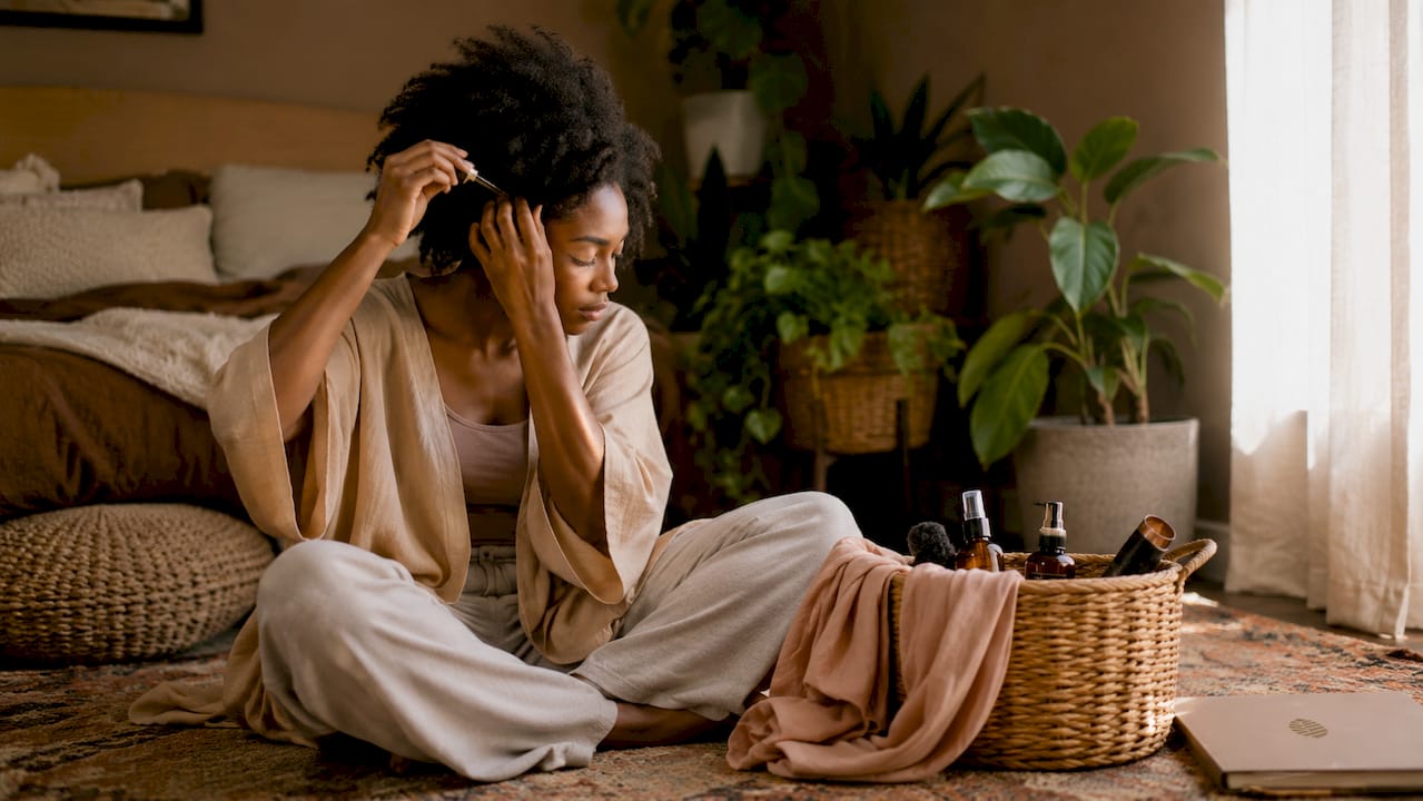 Woman preparing natural hair for wrapping