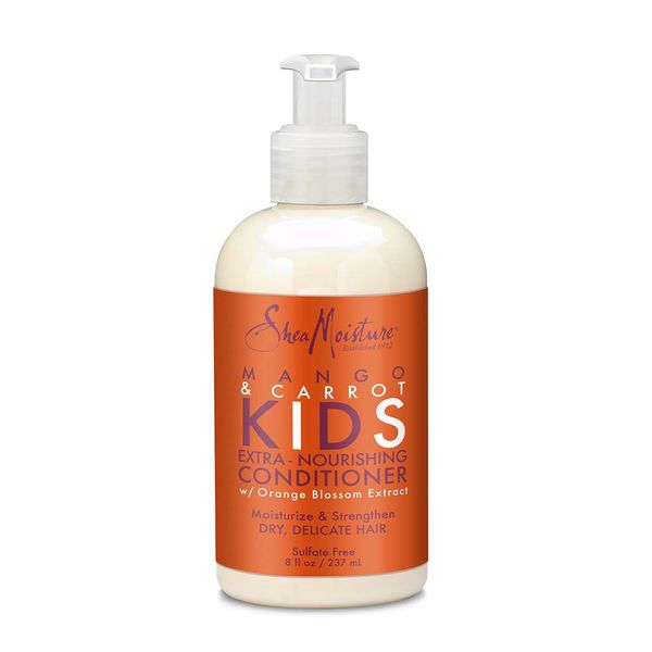 A pump bottle of Shea Moisture Mango & Carrot Kids Extra-Nourishing Conditioner for kids curly hair.