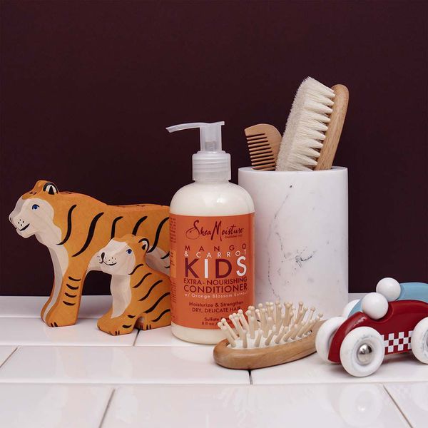 Lifestyle pic  of Shea Moisture Mango & Carrot Kids Extra-Nourishing Conditioner for kids curly hair.
